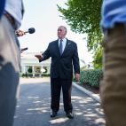 Tom Homan in front of the White House talking to press with microphones